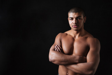 Fototapeta premium Handsome young african sportsman with arms crossed