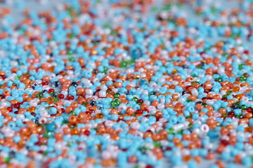 Multi-colored beads, blue background, glass bulb