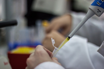 Modern scientist working in biotechnological laboratory equipmen