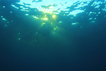 Underwater sunburst and ocean background photo