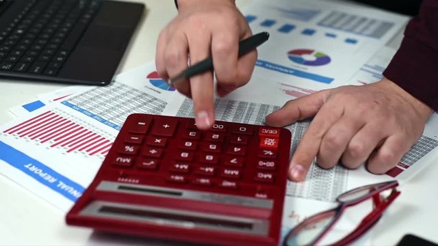 Businessman On The Calculator To Calculate Income. Close Up
