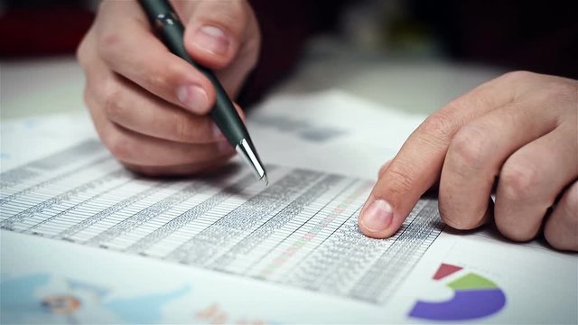 Accountant Man Checks Financial Report And Analyzes Stock Exchange Statistics