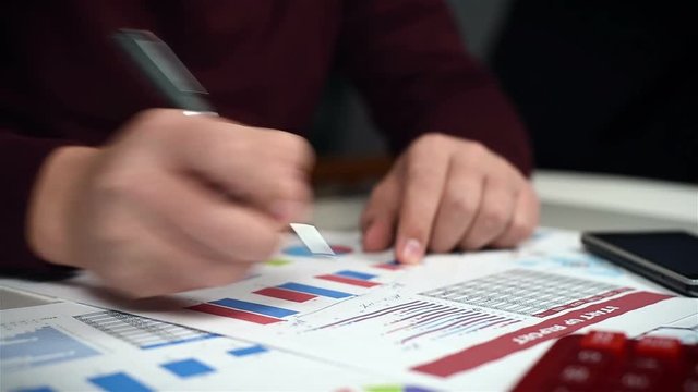 Businessman Monitoring Stock Statistics. Close Up