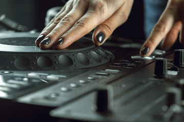 DJ playing music at mixer closeup