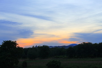 Naklejka na ściany i meble sunset colorful and silhouette woodland, twilight in nature
