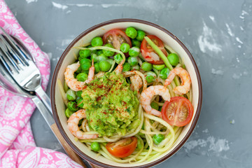 Zucchini pasta with shrimps and avocado in the bowl. Love for a healthy food concept