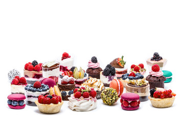 Selection of miniature cakes, macrons, cupcakes and treats - obrazy, fototapety, plakaty