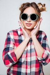 Vertical portrait of young Woman in shirt and sunglasses