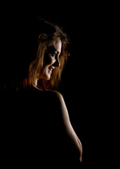 Elegant curves of female shoulders and neck, Redhead girl on a dark background