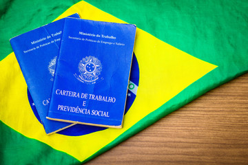 Brazilian work document and social security document (Portuguese: Carteira de Trabalho) on brazilian flag