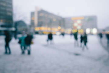 Crowd of people in city in winter, intentional out of focus blur for anonymity