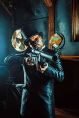 Fototapeta na wymiar Mature gentleman with a rifle on the dark room background.