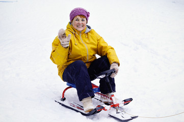 Elderly woman sitting on snowracer