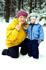 Grandmother with grandson walk in winter  forest