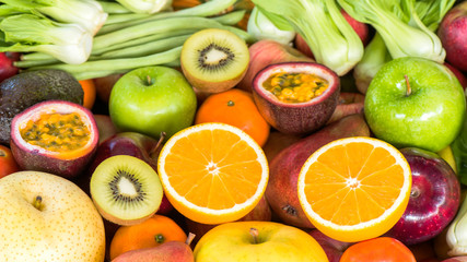 Closeup orange slice with fresh fruits and vegetables