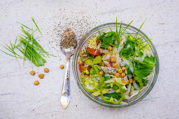 Green wheat and mixed salad with chickpeas in a bowl. Homemade healthy food  lots of seasonings