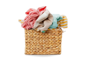 Clothes in a laundry wooden basket isolated on white background
