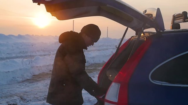 the guy puts things in the trunk of a car. the evening Twilight.