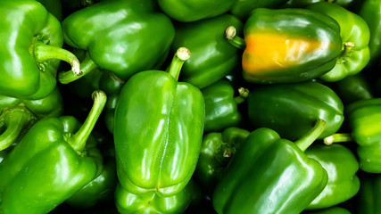 Fresh harvest of green and red peppers in local fruit market