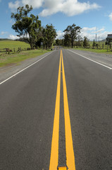Double yellow line markings on straight paved road