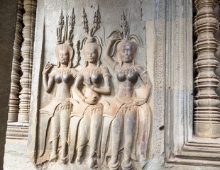 Stone carving of angels or Apsara on the wall of Angkor Wat, the ancient Hindu temple complex in Cambodia