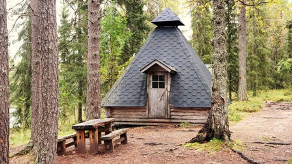 Sami tepee hidden in forest, Lapland © Ilona
