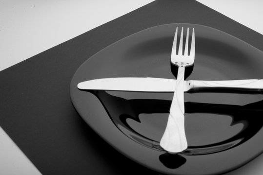 knife, fork and plate on a white background