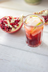 Fresh pomegranate drink - lemonade or cocktail with lime and ice