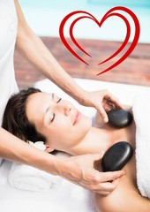 Obraz na płótnie Canvas Masseur giving stone massage to woman at spa