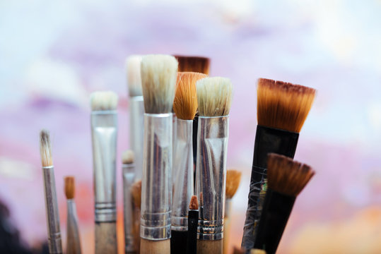 Close up of professional brushes on colorful background