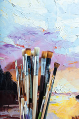 Close up of soft brushes and colorful canvas