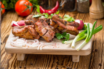 Assorted delicious grilled meat with vegetable on white plate  picnic table for family bbq party
