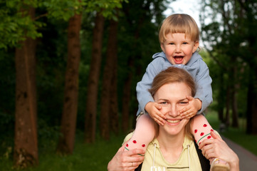 Mother and daughter, daughter over mother, smiling, walk in park
