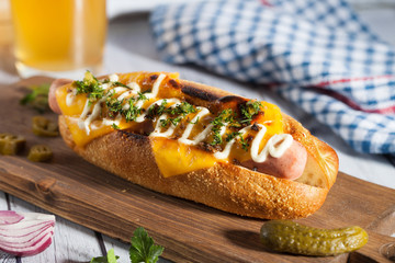 Hot dog with cheese and beer