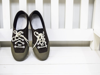 Sneakers Brown on white wooden chair