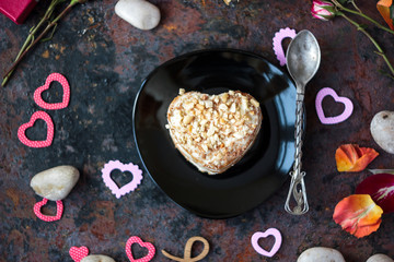 Beautiful heart cake ready to eat on black plate.