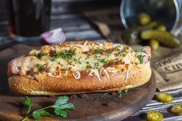 Hot dog with cheese and beer