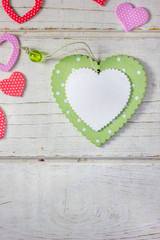 Colored hearts over wooden background - Valentine's day concept