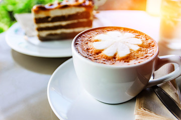 Hot cups of coffee and coffee cake  on table in Coffee Shop Cafe Restaurant Relaxation Concept