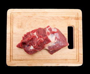meat on the board on a black background