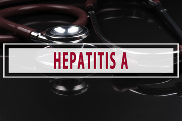 Stethoscope on black background with text HEPATITIS A