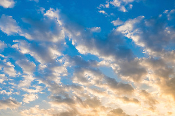 Blue sky background with white clouds. sunset light