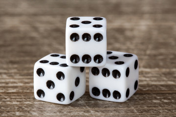 Three dice on wooden table