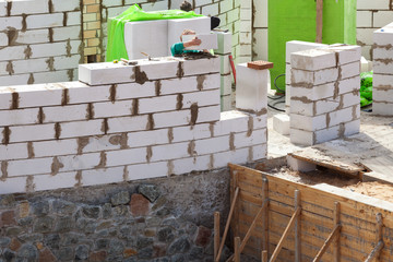 Constraction workers building a roundhouse with aerated autoclaved concrete blocks