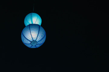 blue Chinese lantern on dark sky