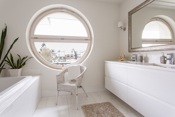 White bathroom with large round window