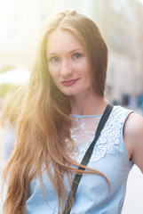 Beautiful Woman with long Hair is walking by City Streets - Happy People Concept - Summer Sunny Photo