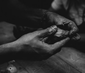 hands with clay