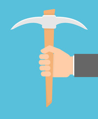 Hand holding pick axe 