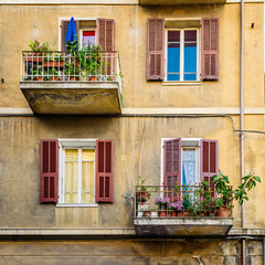 Fototapeta na wymiar Beautiful old facade with shutters on the windows. Italy.